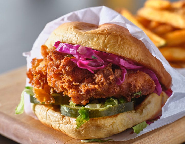 Fried chicken sandwich with lettuce and pickled vegetables, promoting batter and breading opportunities