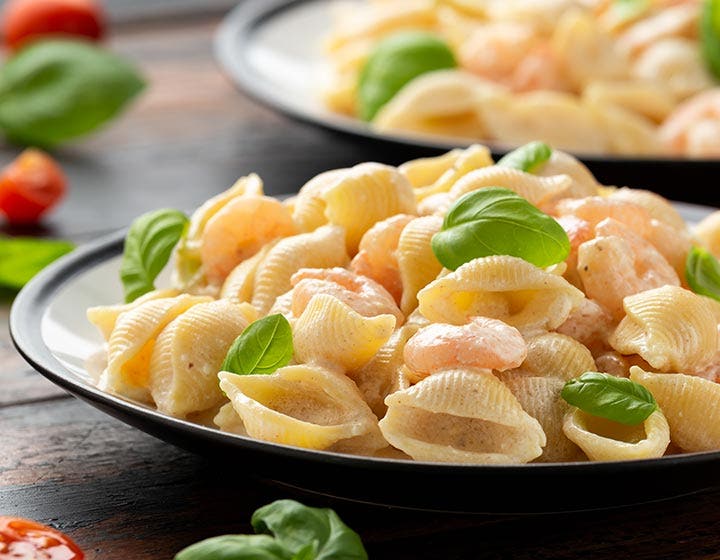 Bowl of pasta shells with vegetables, representing ready meal solutions