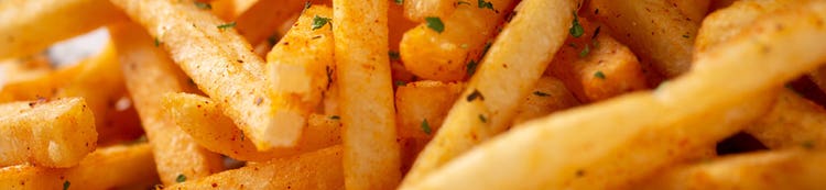 Golden French fries close-up, representing crispy batters and breadings solutions