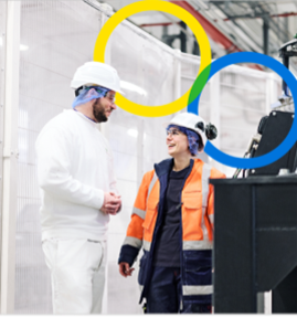 A person and person wearing hard hats and standing in a factory AI-generated content may be incorrect.